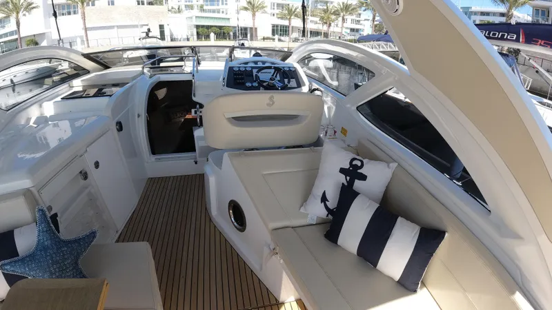  Yacht Photos Pics 2016 Beneteau GT35 yacht interior with plush seating and nautical-themed pillows.