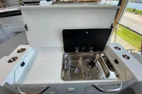 2023 Quarken 27 T-Top V2 boat kitchen with sink and stove setup.