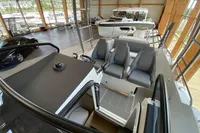 2023 Quarken 27 T-Top V2 boat interior with modern seating in a showroom.