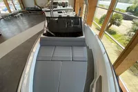 2023 Quarken 27 T-Top V2 boat with sleek design in a showroom setting.