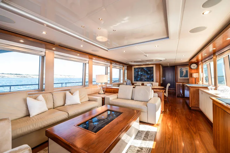 Firefly Yacht Photos Pics Luxurious interior of 2015 Mulder 94 yacht with elegant wood finishes and plush seating.