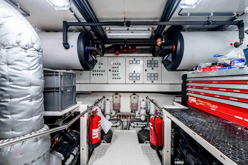 Firefly Yacht Photos Pics Engine room of a 2015 Mulder 94 yacht with control panels and equipment.