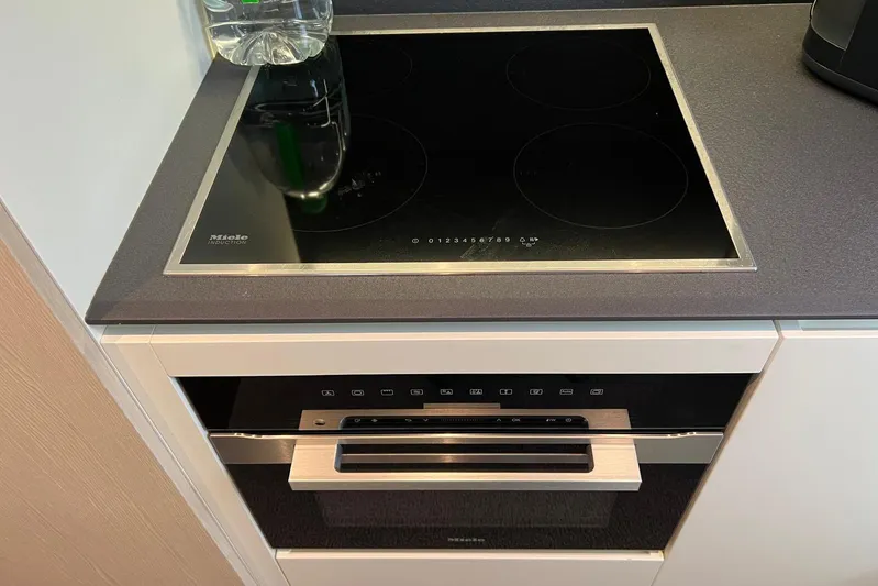 Yacht Photos Pics Modern kitchen with Miele induction cooktop and oven on Azimut Grande 25M yacht.