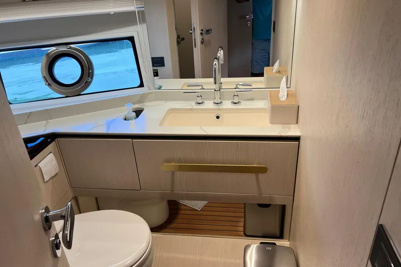  Yacht Photos Pics Luxurious bathroom in 2020 Azimut Grande 25M yacht with modern fixtures and porthole window.