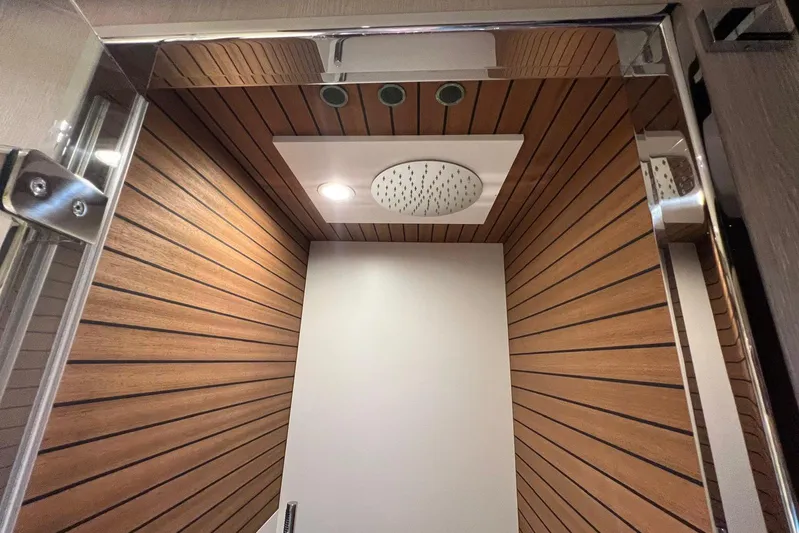  Yacht Photos Pics Luxurious shower interior on 2020 Azimut Grande 25M yacht with wood paneling and modern fixtures.