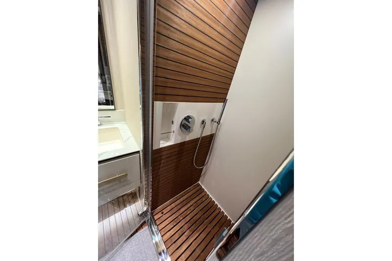  Yacht Photos Pics Luxurious shower area in 2020 Azimut Grande 25M yacht with wood paneling.