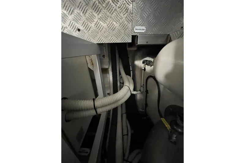  Yacht Photos Pics Engine room of 2020 Azimut Grande 25M yacht with visible hoses and metal flooring.