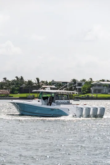 Relentless Yacht Photos Pics 2021 HCB 53 Sueños boat cruising on a sunny day near waterfront homes.