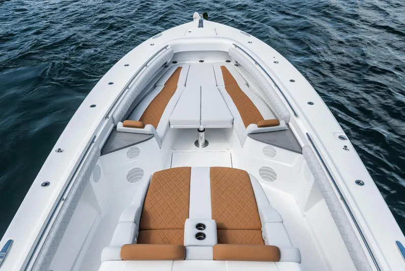 Relentless Yacht Photos Pics Luxury HCB 53 Sueños boat interior with tan seating, 2021 model on water.