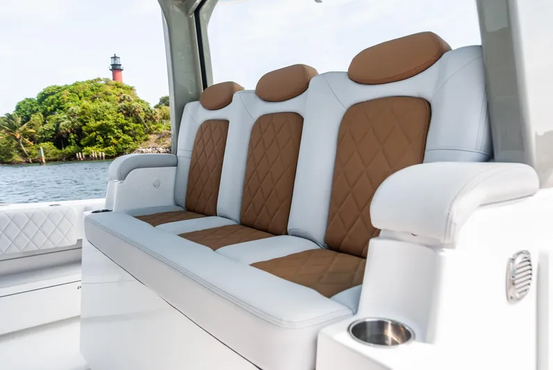 Relentless Yacht Photos Pics Luxurious seating on 2021 HCB 53 Sueños boat with scenic lighthouse view.
