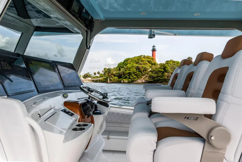 Relentless Yacht Photos Pics Interior of 2021 HCB 53 Sueños boat with lighthouse view in background.
