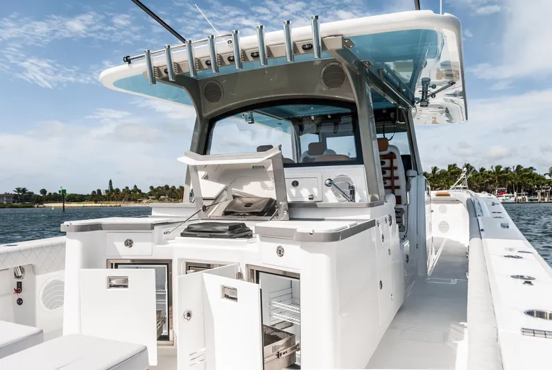 Relentless Yacht Photos Pics 2021 HCB 53 Sueños boat with open storage compartments and sleek design on the water.