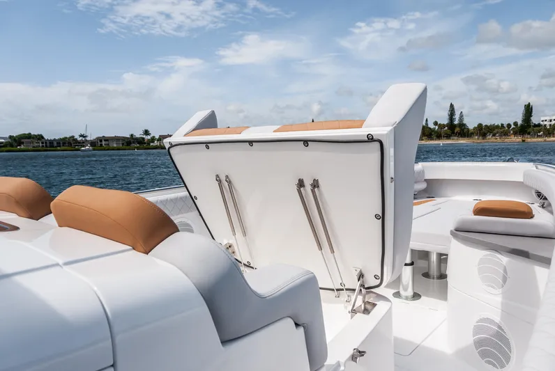 Relentless Yacht Photos Pics 2021 HCB 53 Sueños boat interior with open storage compartment, tan and white seating.