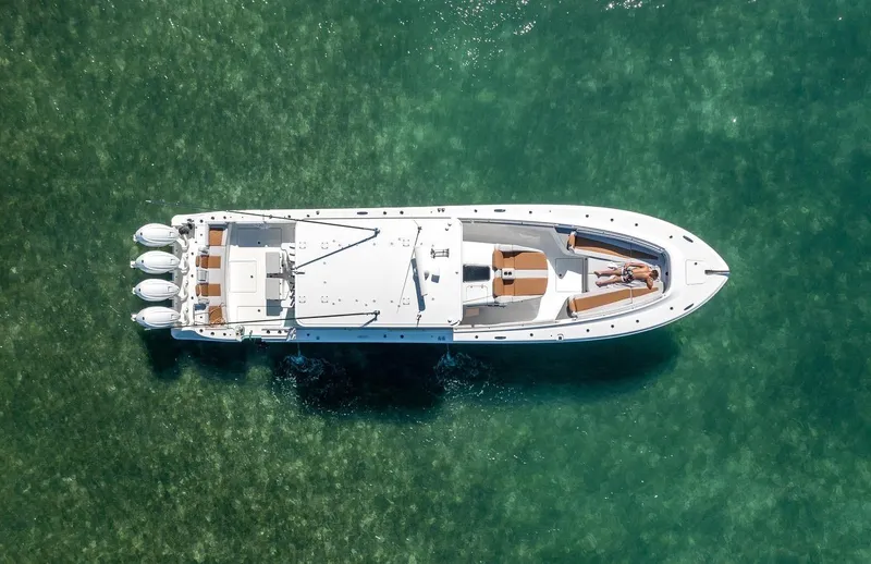 Relentless Yacht Photos Pics Aerial view of 2021 HCB 53 Sueños yacht on clear turquoise water.