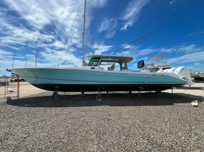 Relentless Yacht Photos Pics 2021 HCB 53 Sueños boat on land under a clear blue sky.