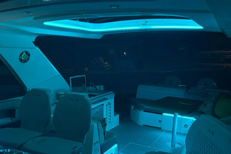  Yacht Photos Pics 2025 Searay 400 SLX yacht interior with ambient blue lighting and modern seating.