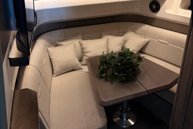  Yacht Photos Pics Luxurious interior of 2025 Searay 400 SLX with plush seating and elegant table setting.
