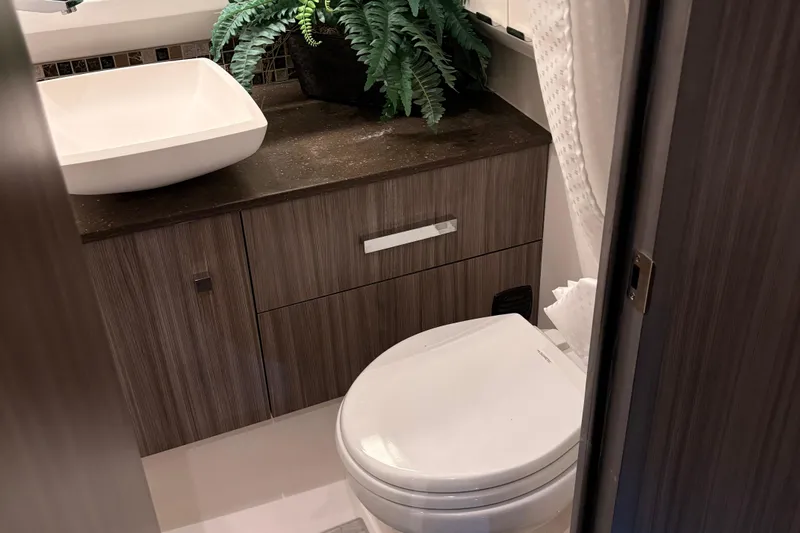  Yacht Photos Pics Modern bathroom in 2025 Searay 400 SLX yacht with sleek sink and toilet.