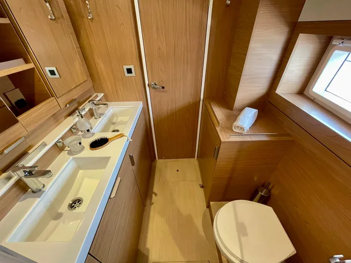 Bali 4.2 Yacht Photos Pics Modern bathroom interior in a 2026 Bali 4.2 yacht, featuring wood accents and dual sinks.