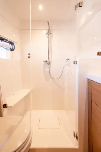 Bali 4.2 Yacht Photos Pics Modern bathroom in Bali 4.2 yacht, 2026 model, featuring sleek shower and wooden cabinetry.