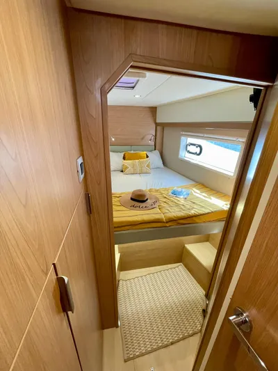 Bali 4.2 Yacht Photos Pics Cozy cabin interior of 2026 Bali 4.2 yacht with bed and window view.