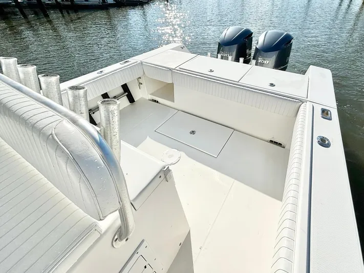  Yacht Photos Pics 2006 Regulator 32 FS boat deck with dual engines, docked on calm water.