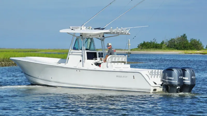  Yacht Photos Pics 2006 Regulator 32 FS boat cruising on water with dual Yamaha engines.