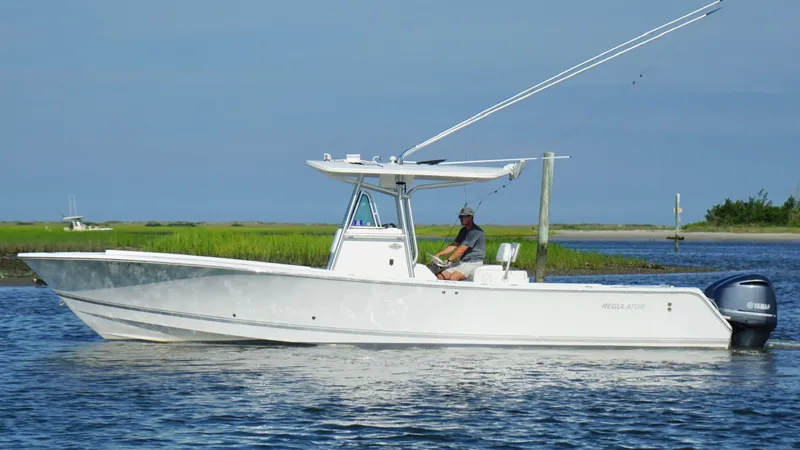  Yacht Photos Pics 2006 Regulator 32 FS boat on calm water with scenic background.