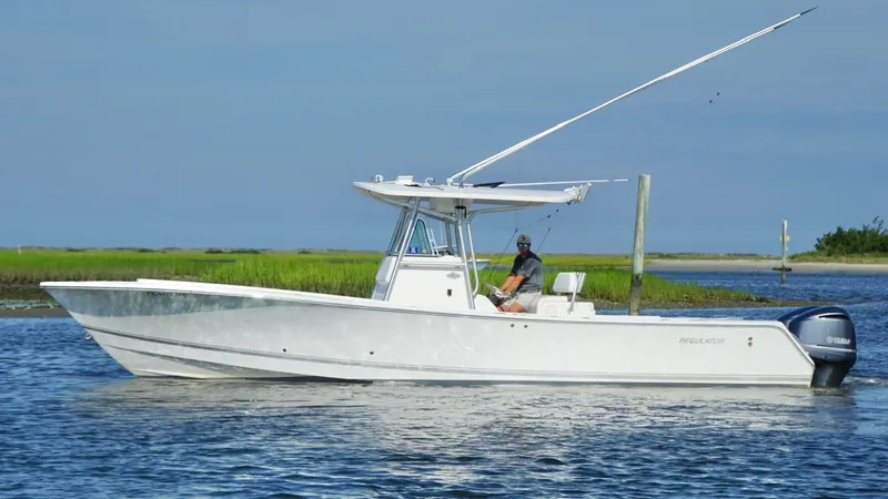  Yacht Photos Pics 2006 Regulator 32 FS boat on water, side view, with clear sky background.
