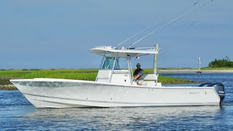 Yacht Photos Pics 2006 Regulator 32 FS boat cruising on calm water with a person at the helm.