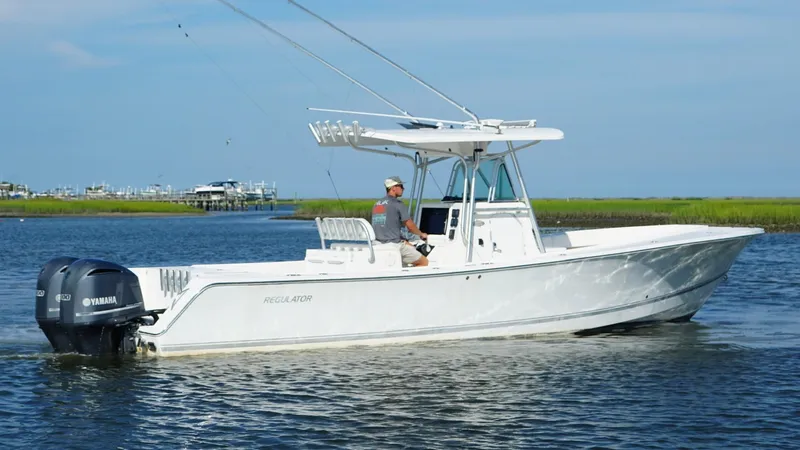  Yacht Photos Pics 2006 Regulator 32 FS boat on water with dual Yamaha engines, clear sky background.