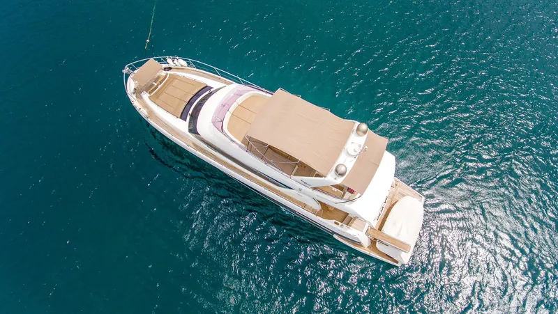  Yacht Photos Pics Aerial view of 2013 Prestige 620 yacht on clear blue water.