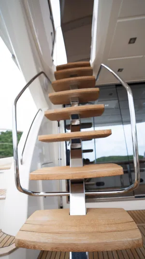  Yacht Photos Pics Staircase on 2013 Prestige 620 yacht with wooden steps and metal railing.