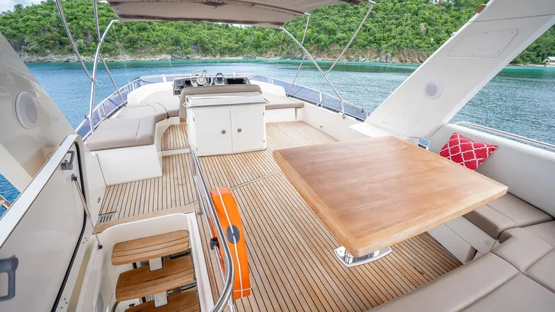  Yacht Photos Pics Luxurious 2013 Prestige 620 yacht deck with seating, table, and scenic ocean view.
