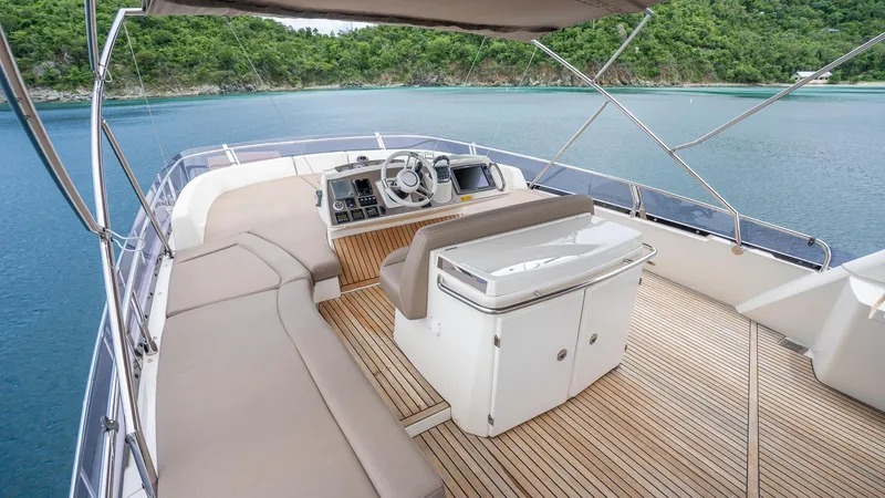  Yacht Photos Pics Flybridge of 2013 Prestige 620 yacht with seating and helm, overlooking serene waters.