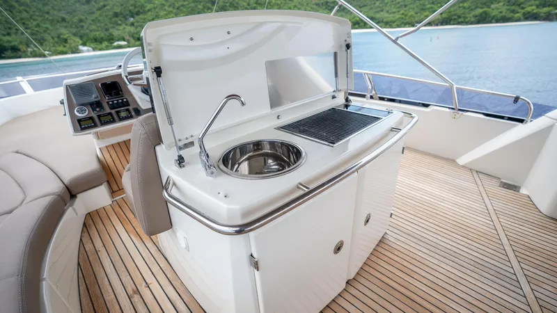  Yacht Photos Pics Prestige 620 yacht's outdoor kitchen with sink and grill, 2013 model, on teak deck.