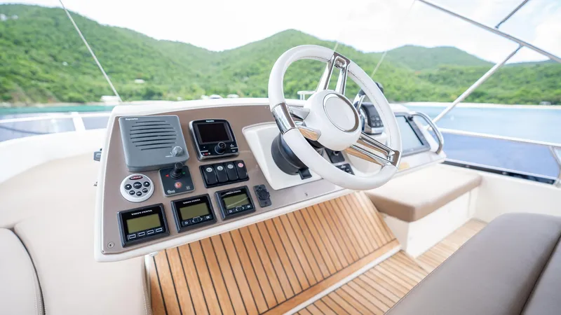  Yacht Photos Pics Cockpit of 2013 Prestige 620 yacht with modern controls and scenic background.