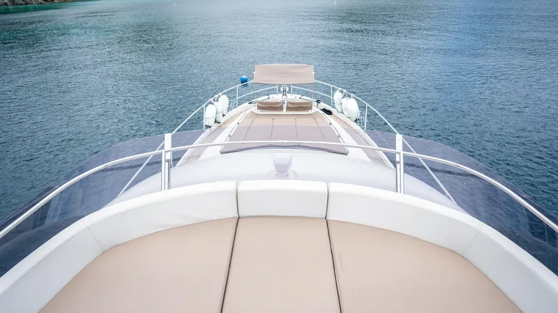  Yacht Photos Pics Front deck view of a 2013 Prestige 620 yacht on calm waters.