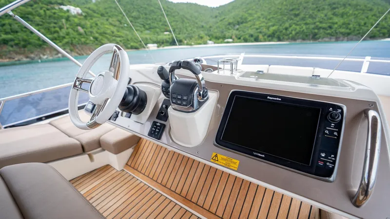  Yacht Photos Pics Prestige 620 yacht helm with modern controls and navigation, 2013 model, scenic ocean backdrop.