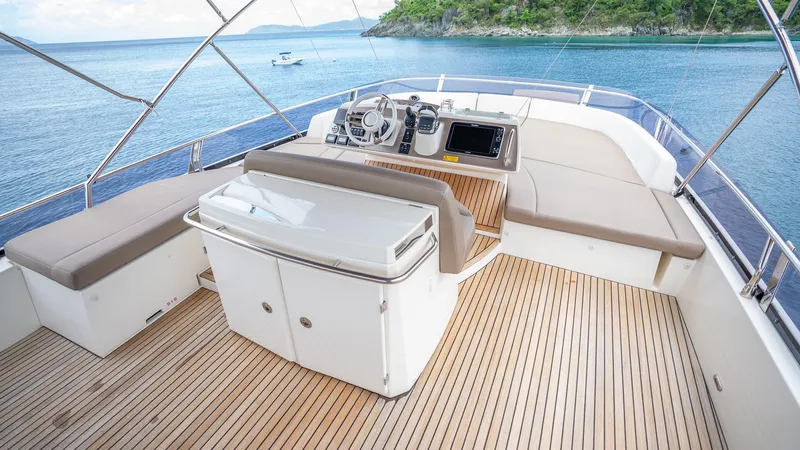  Yacht Photos Pics Flybridge of 2013 Prestige 620 yacht with seating and helm, overlooking serene waters.