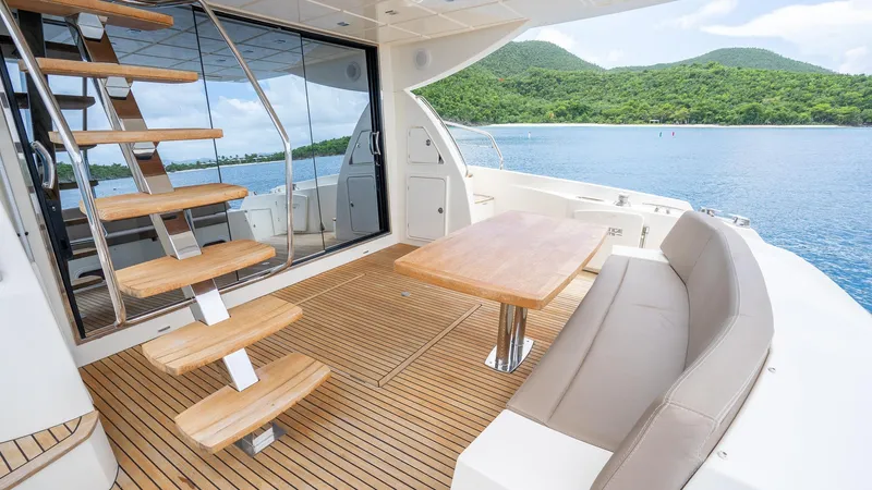  Yacht Photos Pics Luxurious 2013 Prestige 620 yacht deck with seating, table, and scenic ocean view.