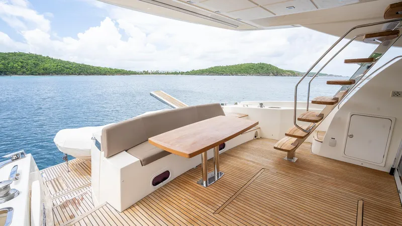  Yacht Photos Pics Luxurious 2013 Prestige 620 yacht deck with seating, table, and ocean view.