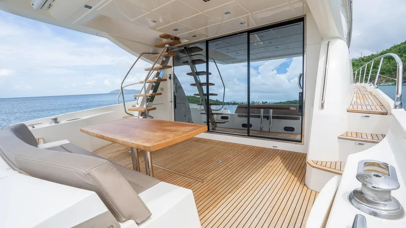  Yacht Photos Pics Luxury yacht deck with wooden flooring, modern seating, and ocean view; Prestige 620, 2013 model.