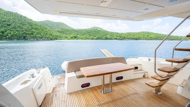  Yacht Photos Pics Luxurious 2013 Prestige 620 yacht deck with scenic ocean and lush green hills.