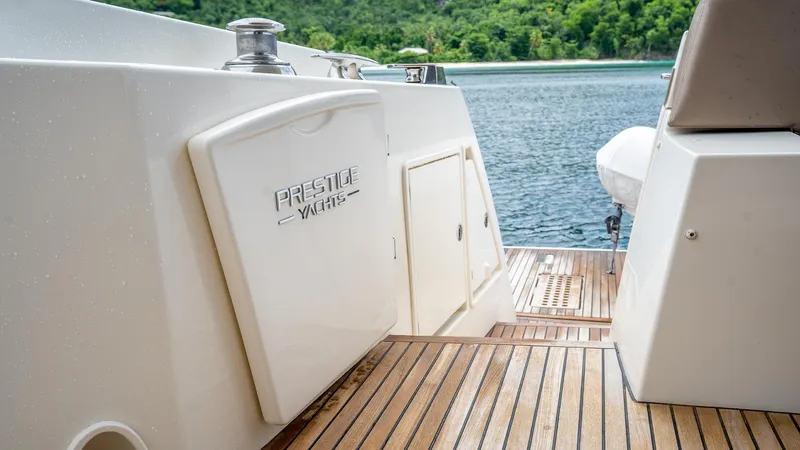  Yacht Photos Pics Prestige 620 yacht deck, 2013 model, with wooden flooring and scenic water view.