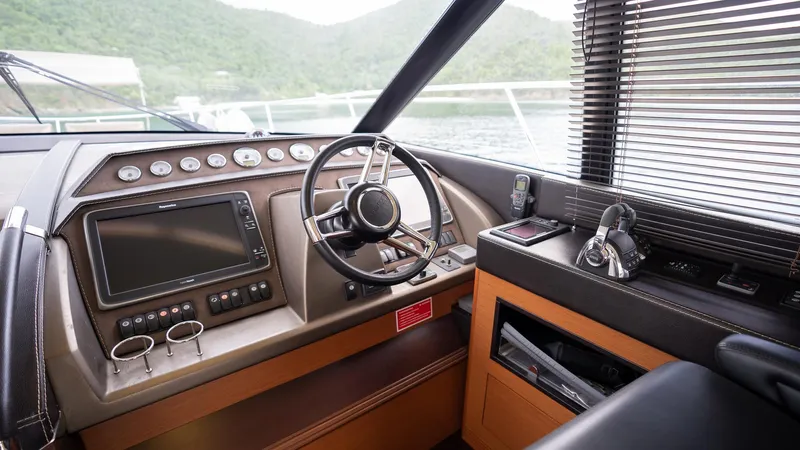  Yacht Photos Pics Cockpit of 2013 Prestige 620 yacht with steering wheel, controls, and navigation equipment.