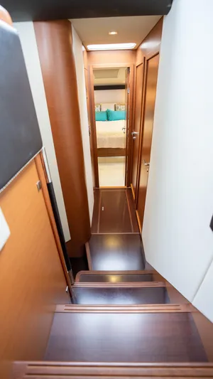  Yacht Photos Pics Interior staircase of 2013 Prestige 620 yacht, leading to a cozy cabin.