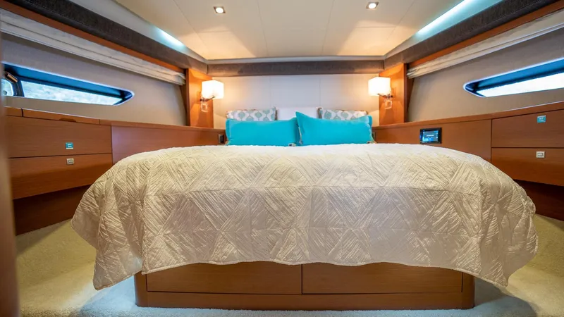  Yacht Photos Pics Luxurious bedroom interior of a 2013 Prestige 620 yacht with elegant bedding and ambient lighting.