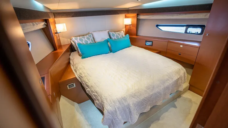  Yacht Photos Pics Luxurious bedroom interior of 2013 Prestige 620 yacht with cozy bedding and elegant lighting.