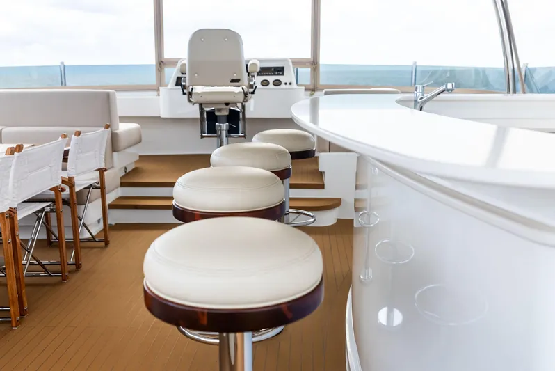 Northland Yacht Photos Pics Luxurious interior of 2017 Burger 104 Motor Yacht with bar stools and helm station.